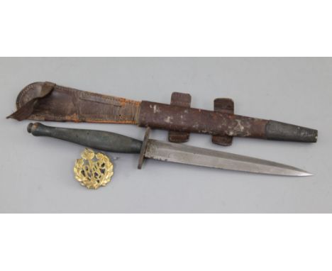 A Wilkinson sword commando knife 'The F.S. Fighting knife', 11.75in., in leather sheath with an RAF brass cap badge