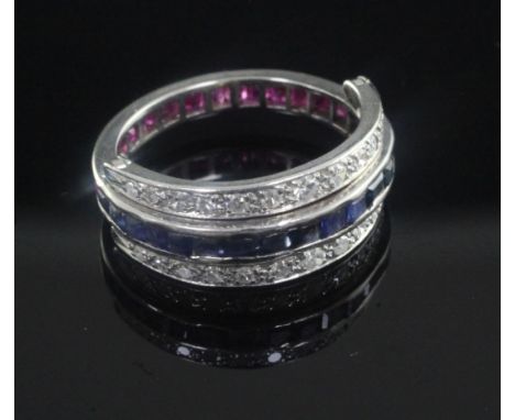 A white gold, ruby, sapphire and diamond set triple band swivel ring, size M.