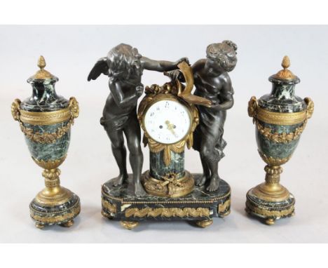 An early 20th century French bronzed spelter, ormolu and green marble clock garniture, the mantel clock modelled with Cupid a
