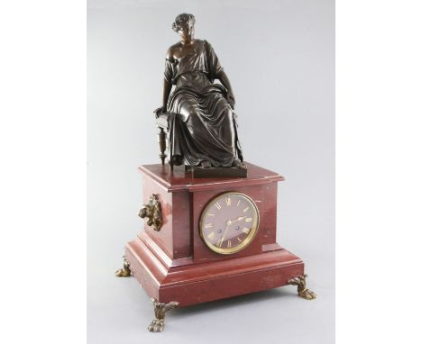 A 19th century French bronze and rouge marble mantel clock, surmounted with the figure of a seated classical woman, on archit