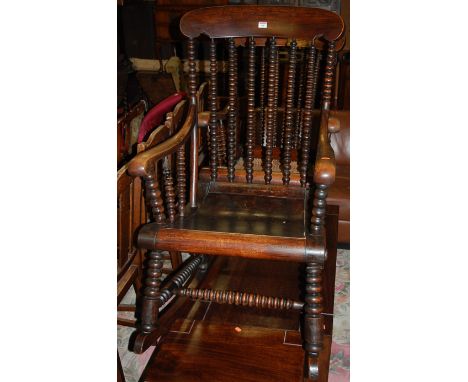 A pair of Victorian rosewood bobbin turned stickback rocking open armchairs, one with panelled seat, the other with cane seat