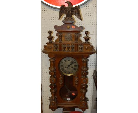 An early 20th century figured walnut Vienna type drop trunk wall clock, the silvered dial signed D Lloyd, Welshpool, with eag