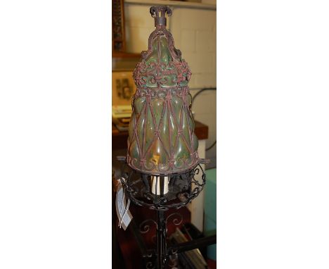 An Arts & Crafts wrought iron standard lamp, having fitted vaseline glass shade, with wirework scroll decoration, h.167cm