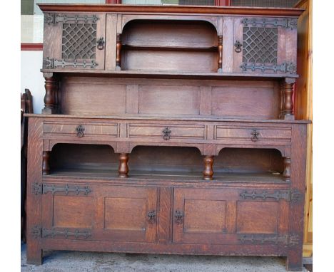 An Arts & Crafts oak and iron bound dresser, the upper section with open single shelf, compartment flanked by twin colour gla