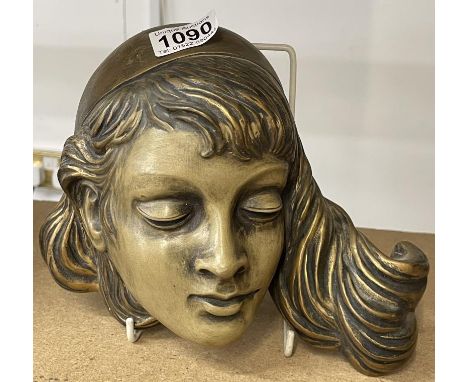 An art deco ceramic wall head of a girl.