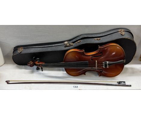 An early 20th century violin copy of a Stradivarius with a case &amp; bow