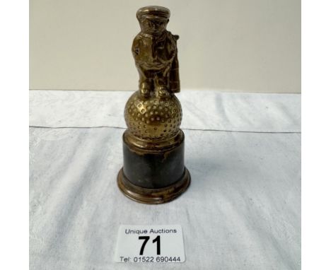 A vintage Dunlop golf caddy car mascot on plinth
