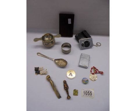 A mixed lot including novelty penknife, Zippo lighter, tea strainer, brooches etc.,