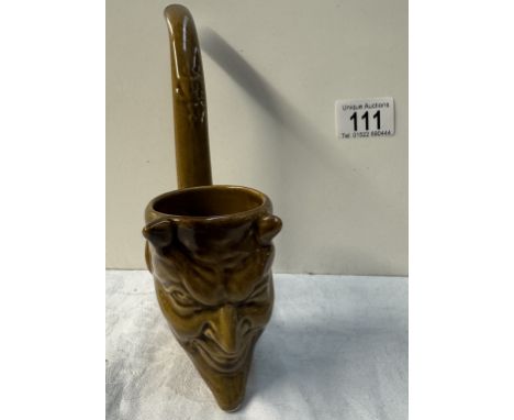 A studio pottery pipe with a devil head bowl