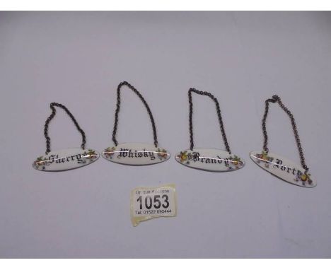 Four hall marked silver and enamel decanter labels.