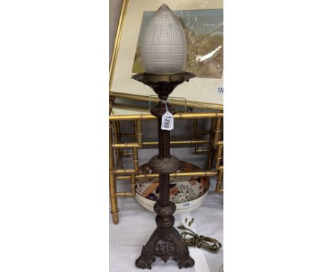 A tall brass pricket lamp with holophane type acorn shade, 75 cm tall. COLLECT ONLY.Holophone 3160 moulded in the glass half 