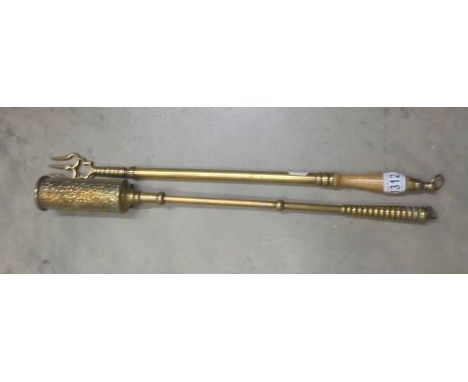 A brass toasting fork and a brass hearth brush.