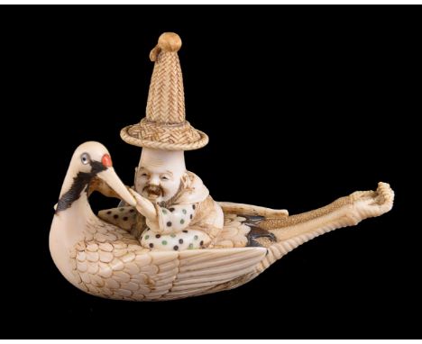 ϒ Yasuyuki: A Japanese Ivory Netsuke of Jurojin, wearing a tall Korean hat as he rides on the back of a Manchurian Crane, its