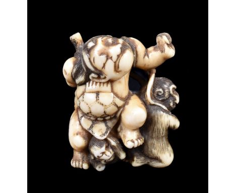 ϒ An Ivory Japanese Netsuke carved as the young Kintaro holding his axe behind his back as two monkeys attempt to steal it, d