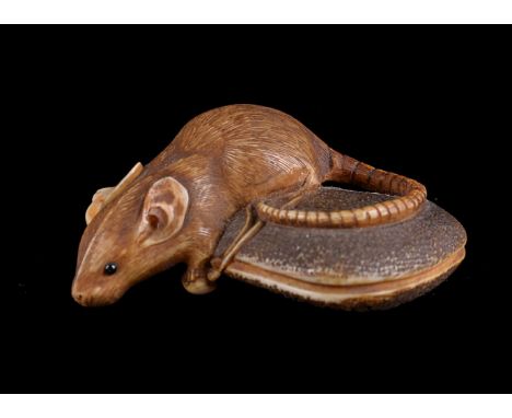 ϒ Shomin: A Japanese Ivory Netsuke, carved as a rat clambering over a kinchaku which is attached to a netsuke shaped as a che