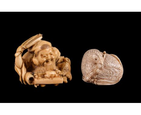 ϒ A Japanese Ivory Netsuke of a seated quail, its head turned to its left as it grips a head of millet in its beak, details e