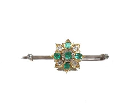 An emerald and diamond set bar brooch, of flowerhead design, claw set with step-cut, cut-cornered emeralds and old mine-cut d