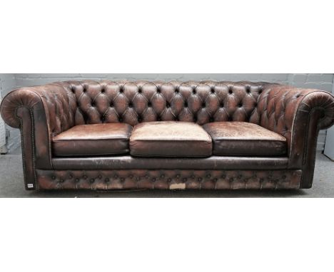 A brown leather button back Chesterfield sofa, with studded decoration, 210cm wide x 70cm high. 