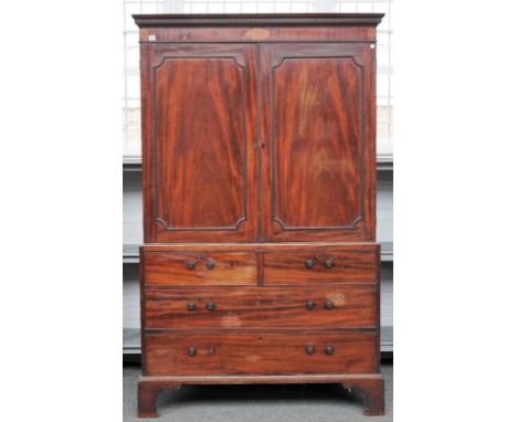 A George III mahogany linen press, the pair of panel doors over two short and two long drawers, on bracket feet, 126cm wide x