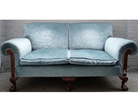 A Chippendale revival roll arm sofa with carved mahogany frame, on claw and ball feet, 190cm wide x 98cm high. 