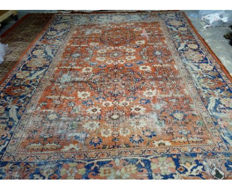 A Mahal carpet, Persian, the madder field with a central flower medallion and two supporting medallions, angular floral spray