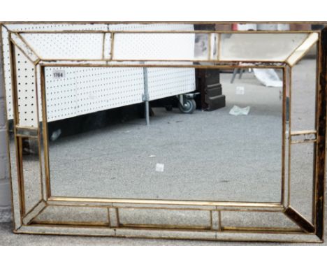 A 20th century cushion framed segmented mirror, 83cm wide x 57cm high, together with an Empire revival gilt metal mounted mir