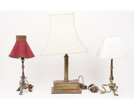 A Victorian style gilt metal table lamp of fluted column form, 60cm high overall, and two further smaller brass table lamps, 