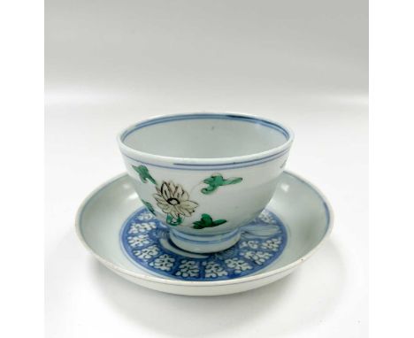 A Chinese wucai porcelain cup, late Ming Dynasty, circa 1600, high footed, painted with three sprigs to the outside wall and 