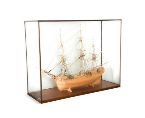 A wooden model of an 18th century sailing ship, 20th century with three main masts and hull ribs exposed, within a glazed dis