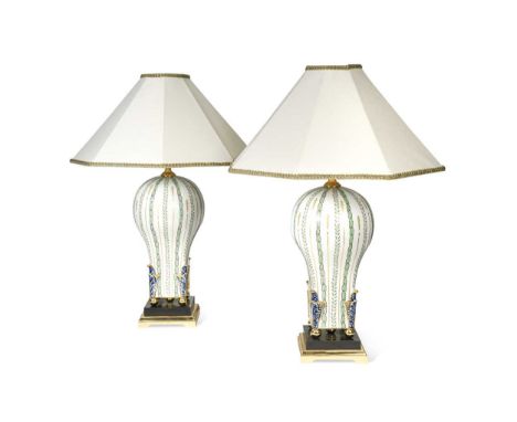 A pair of Giulia Mangani porcelain table lamps and shades, of baluster form and decorated with gilt and transfer printed foli