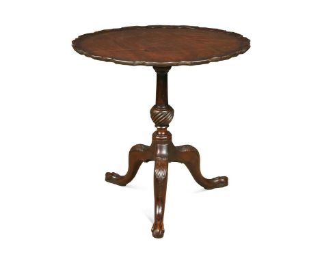 A George III style mahogany tripod table, 19th century, the associated pie crust tilt-top over wrythen turned column support 