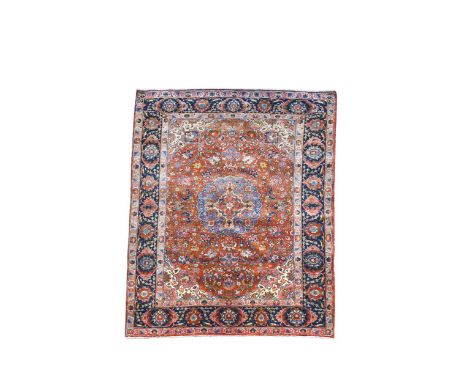 An Isfahan rug, circa 1950, the central pale indigo medallion on a rust-coloured field and wide indigo border195 x 144cmPleas