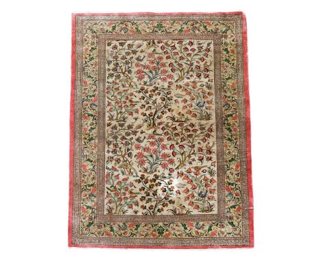 A Tabriz silk rug with a neutral field of birds within trees107 x 158cmPile is excellent with no obvious wear except to a sma