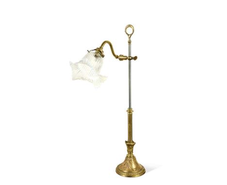 A brass and steel adjustable reading lamp, French, 19th century, the tulip shaped vaseline glass shade on an adjustable arm a