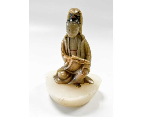 A Chinese carved soapstone figure of Guanyin, Qing Dynasty, early 19th century, seated holding a scroll in her right hand9cm 
