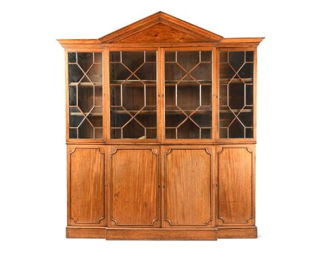 A George III and later mahogany breakfront bookcase, with architectural pediment, the upper part enclosed by astragal glazed 