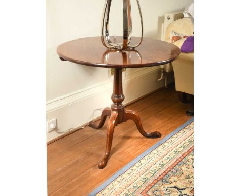 A George III mahogany circular tripod table, with snap top on a tapering column73 x 83cm