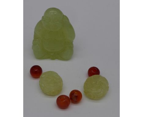 A carved jade Buddha, jade and hardstone beads