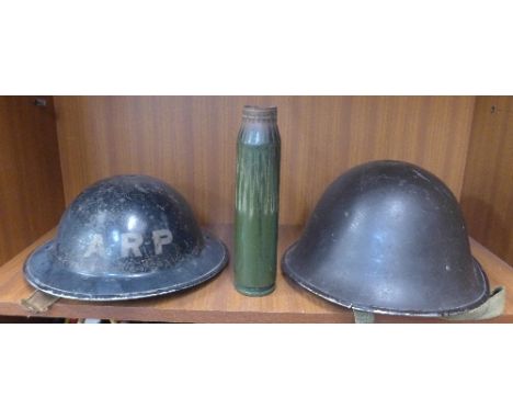 A WWII A.R.P. helmet and a British helmet plus an Argentinean 35mm shell case from the Falklands Conflict with C.O.A.