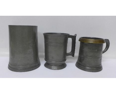 Three pewter mugs;- a Victorian quart and two early pint mugs, both pint mugs bear inscriptions to the bases, J. Jones The Sw