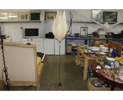 A metal standard lamp with leaf shaped shade