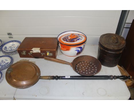 An antique copper warming pan with turned wooden handle, an iron skillet, a tin hat box, a vintage leather suitcase and a coo