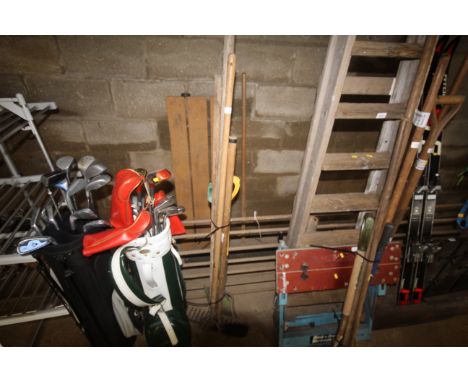 A quantity of long handled garden tools to include rake, hoes, etc.