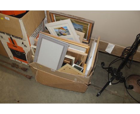 A box of miscellaneous picture frames and prints etc
