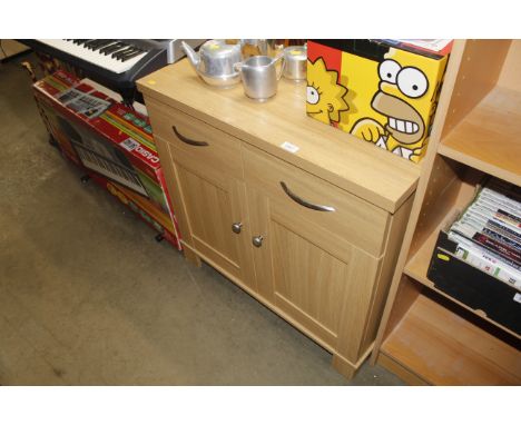 A modern light oak effect side cupboard, fitted two drawers