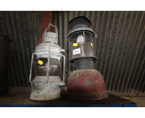 A galvanised hanging oil lamp and a Bialaddin Tilley lamp with swing handle