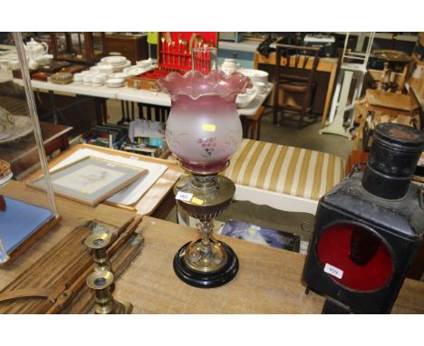 A brass and copper arts and crafts style oil lamp with glass shade 