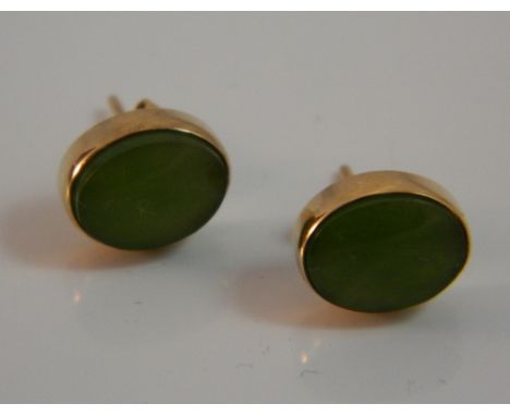 A pair of 14 K gold and jade earrings