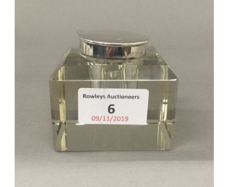 A silver top glass inkwell