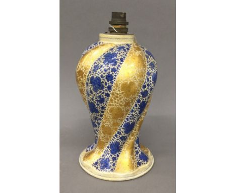 An Indian Kashmiri papier mache lamp base, spiral moulded and decorated with blue and gilt strapwork paper label to underside